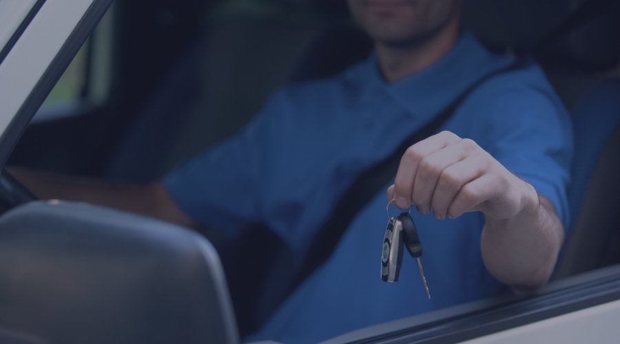 Man in truck holding keys out the window