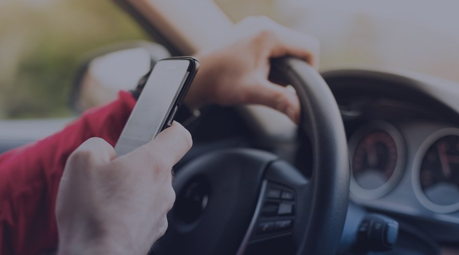 Driver using their phone while driving.