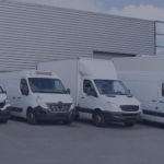 Fleet of vehicles parked outside of a business.