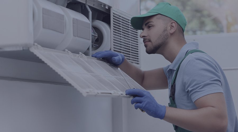 Repair man looking at HVAC