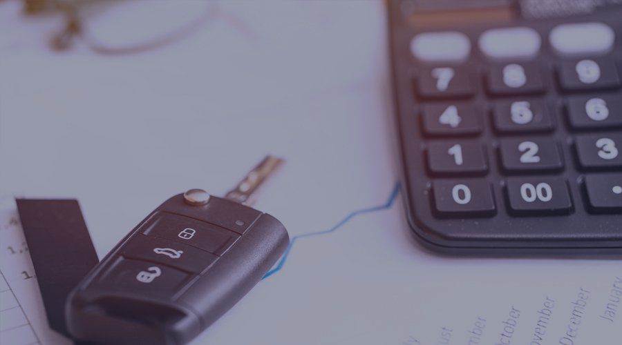 Car key beside calculator on desk