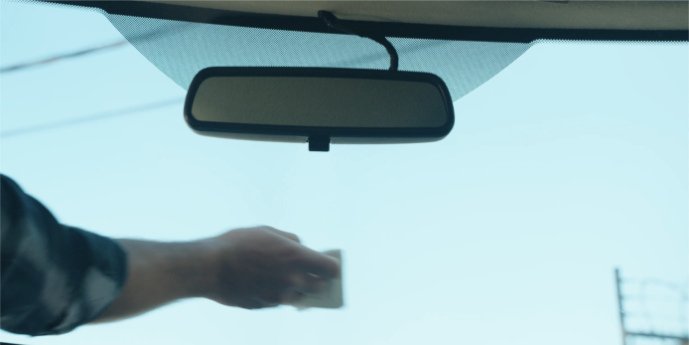 Person cleaning windshield