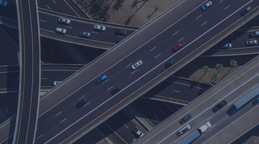 Multiple three-lane highways with traffic.